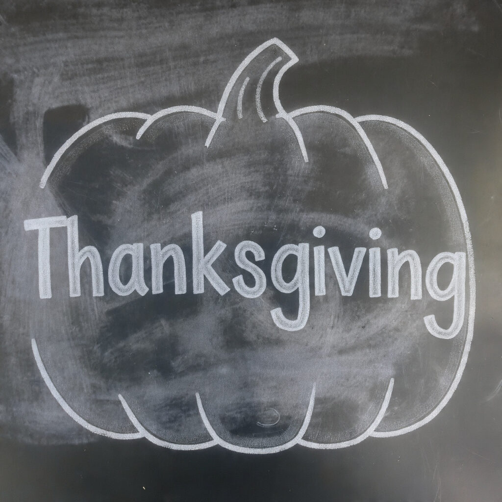a thanksgiving chalkboard with a large simple
