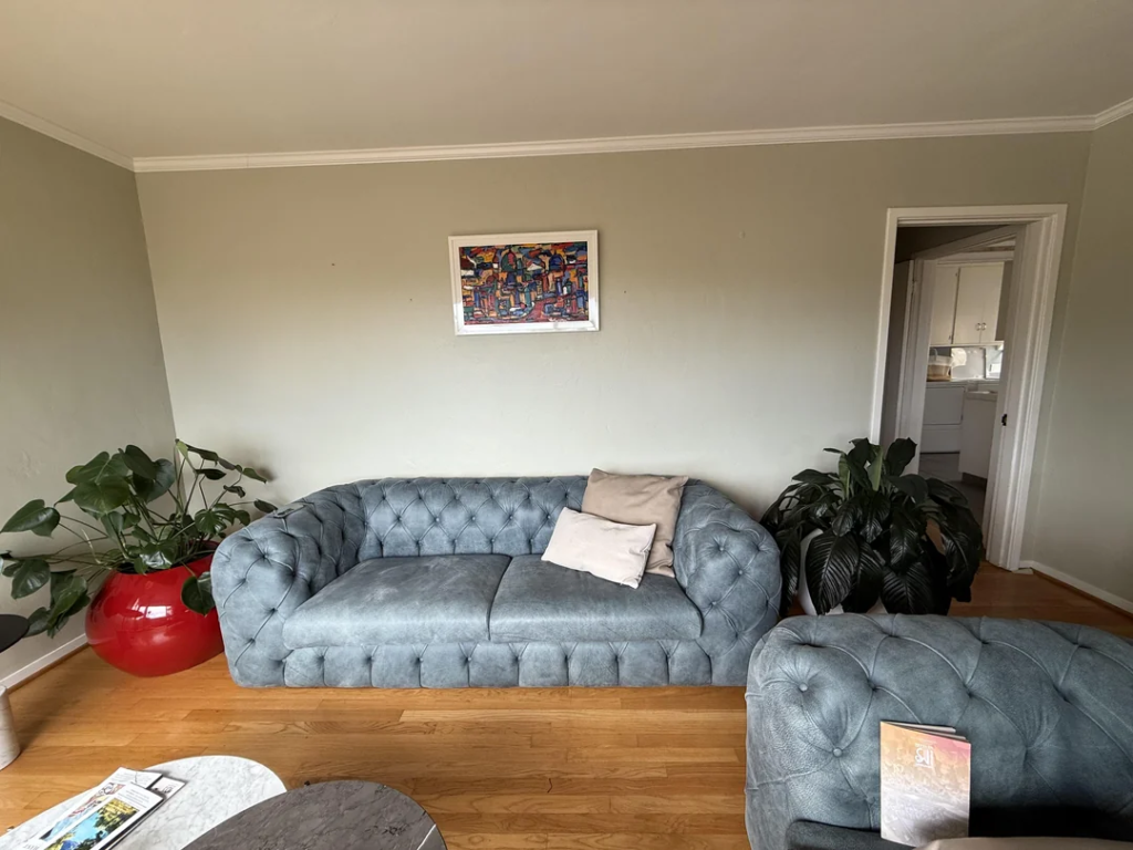 26 Apartment Reading Nook Ideas That Make Small Spaces Feel Warm, Stylish, and Super Cozy 9 A Slim Arc Floor Lamp