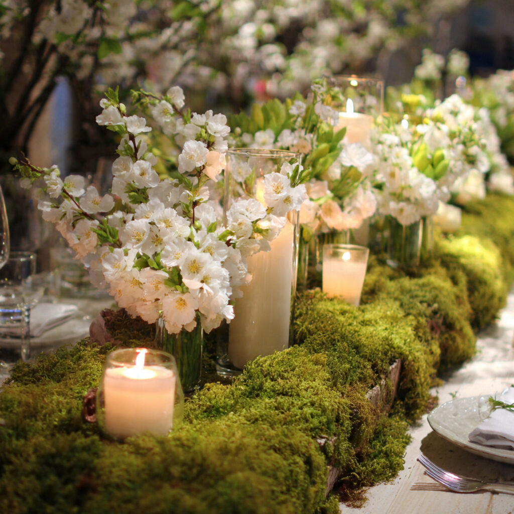 Blossom and Candle Mixed Centerpiece Along a Moss Runner